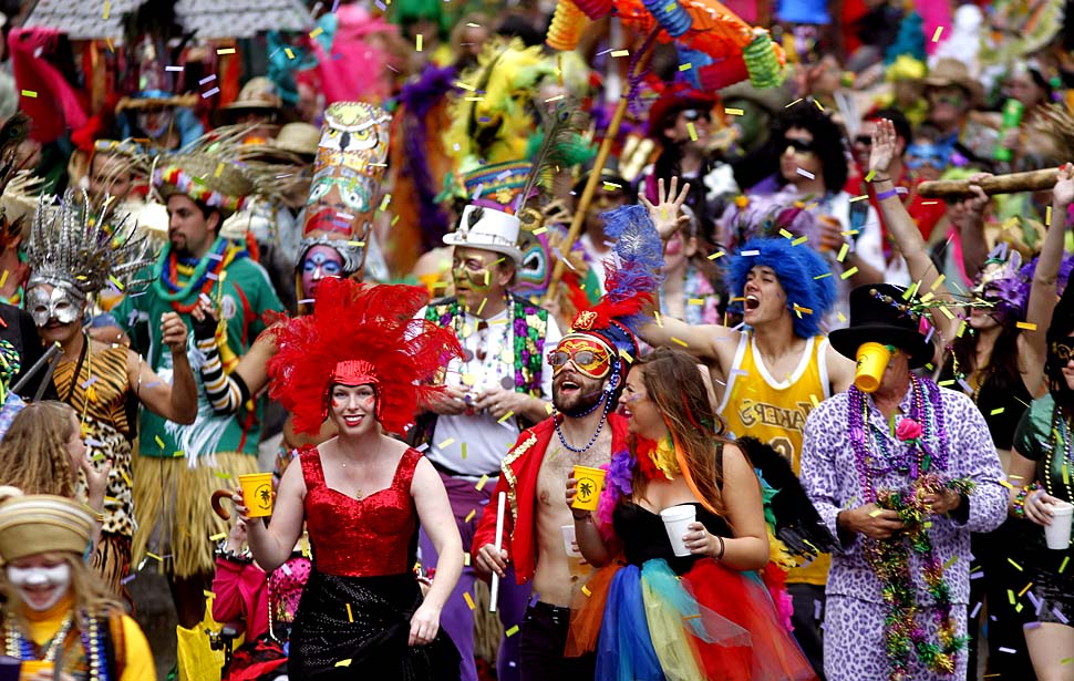 A marching group arrives at Canal Street as it marches ahead of the Krewe of Zulu on Mardi Gras Day in New Orleans, Tuesday, March 8, 2011.